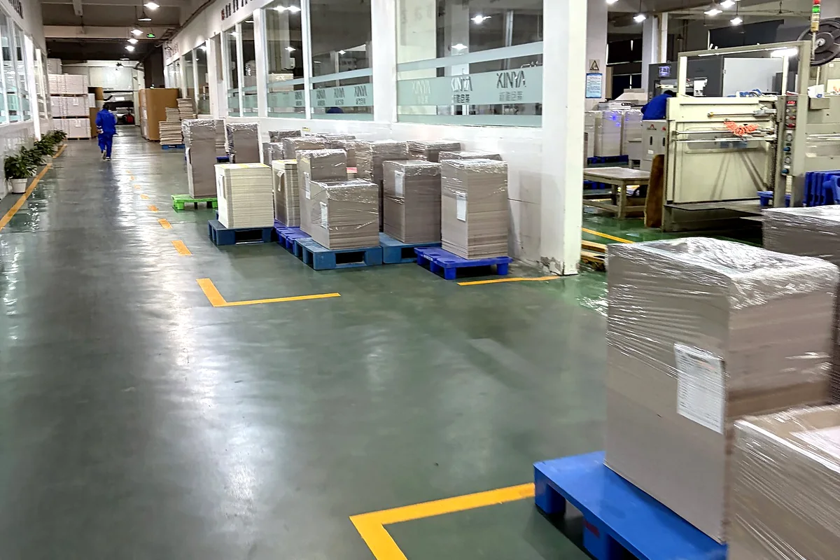Organized packaging production aisle with palletized materials prepared for factory workflow