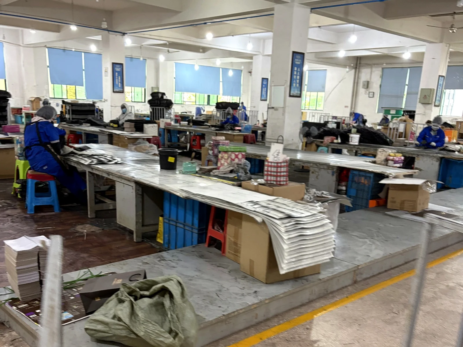 Workers assembling and packing Christmas cracker components