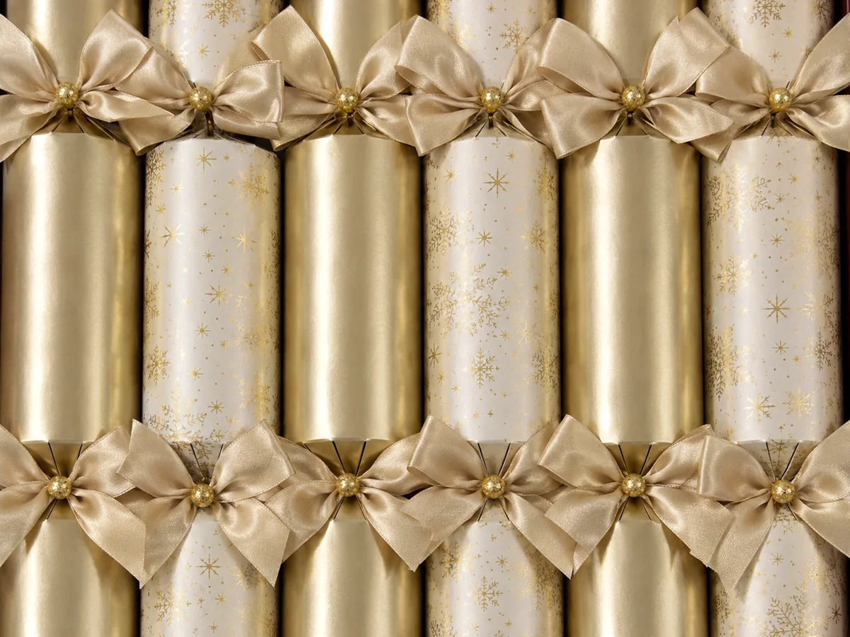 Gold and ivory Christmas crackers with snowflake print and satin bows