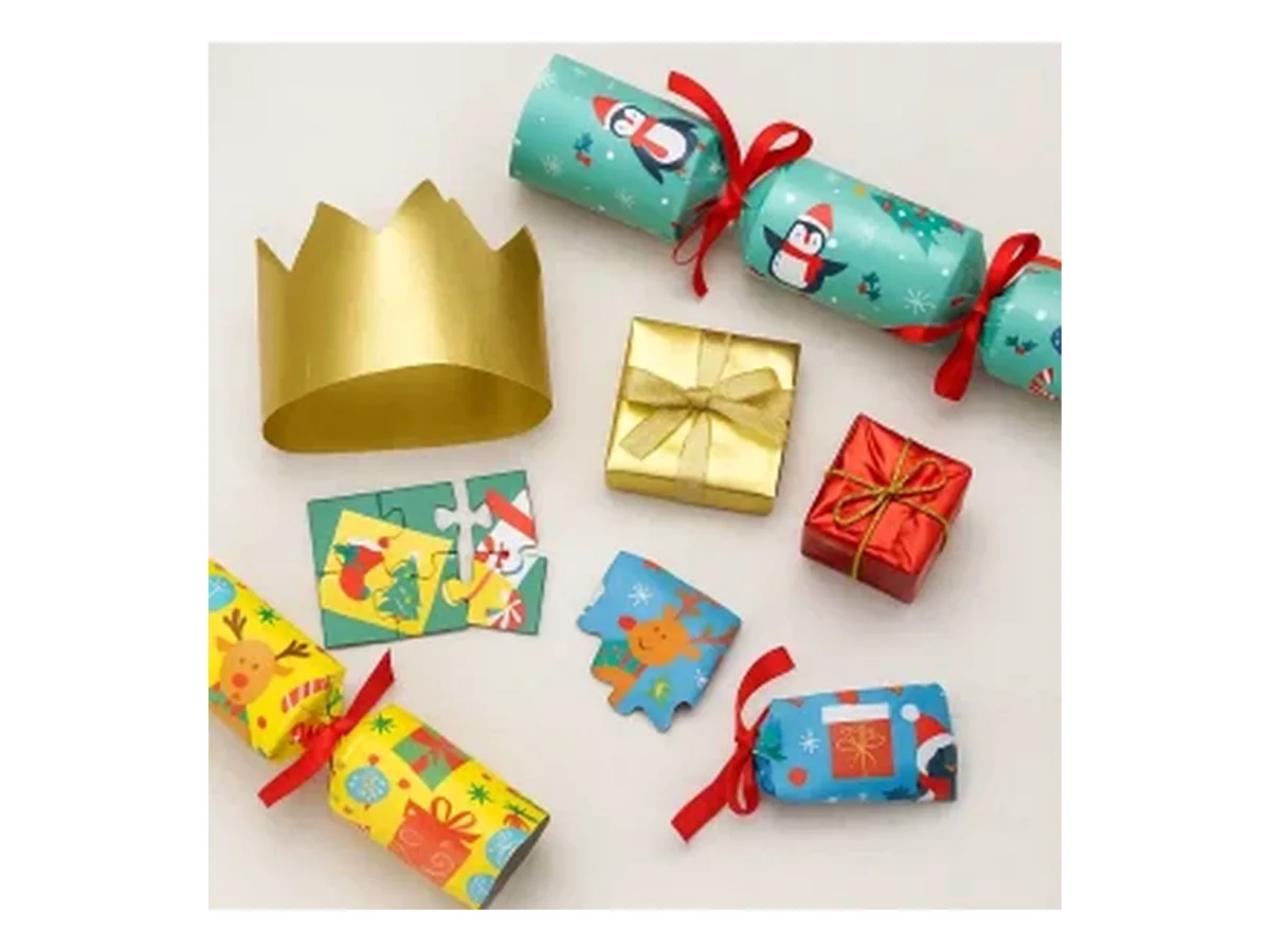 Christmas crackers shown with a paper crown, gifts and puzzle pieces