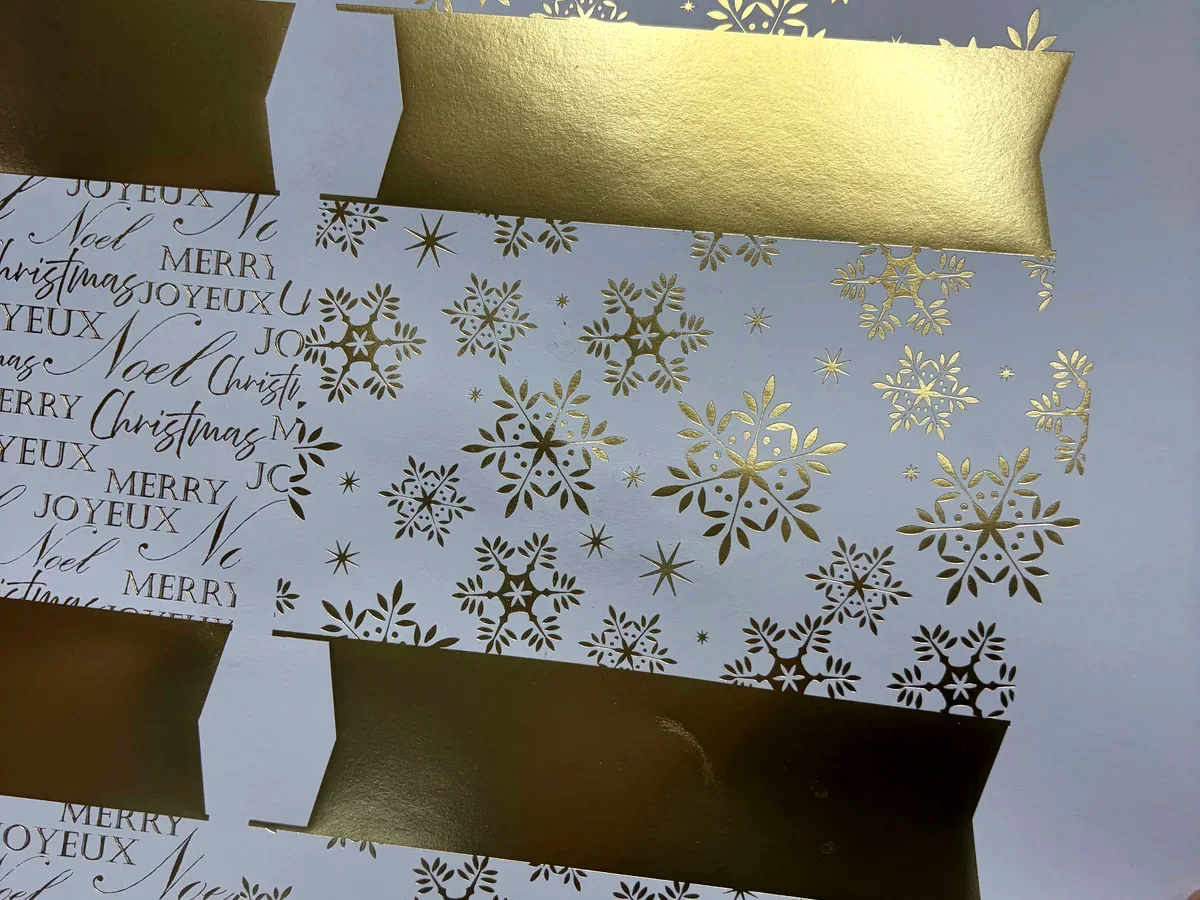 Gold foil printing details on Christmas cracker artwork before assembly
