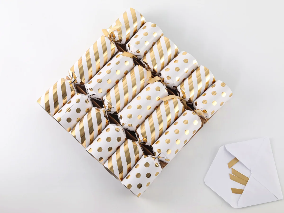 Gold and white Christmas crackers arranged for premium presentation