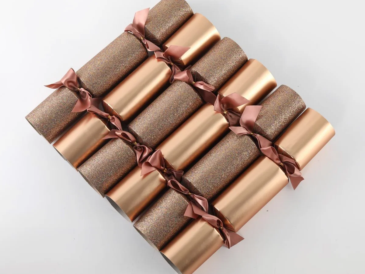 Rose gold luxury Christmas crackers presented as a coordinated premium range