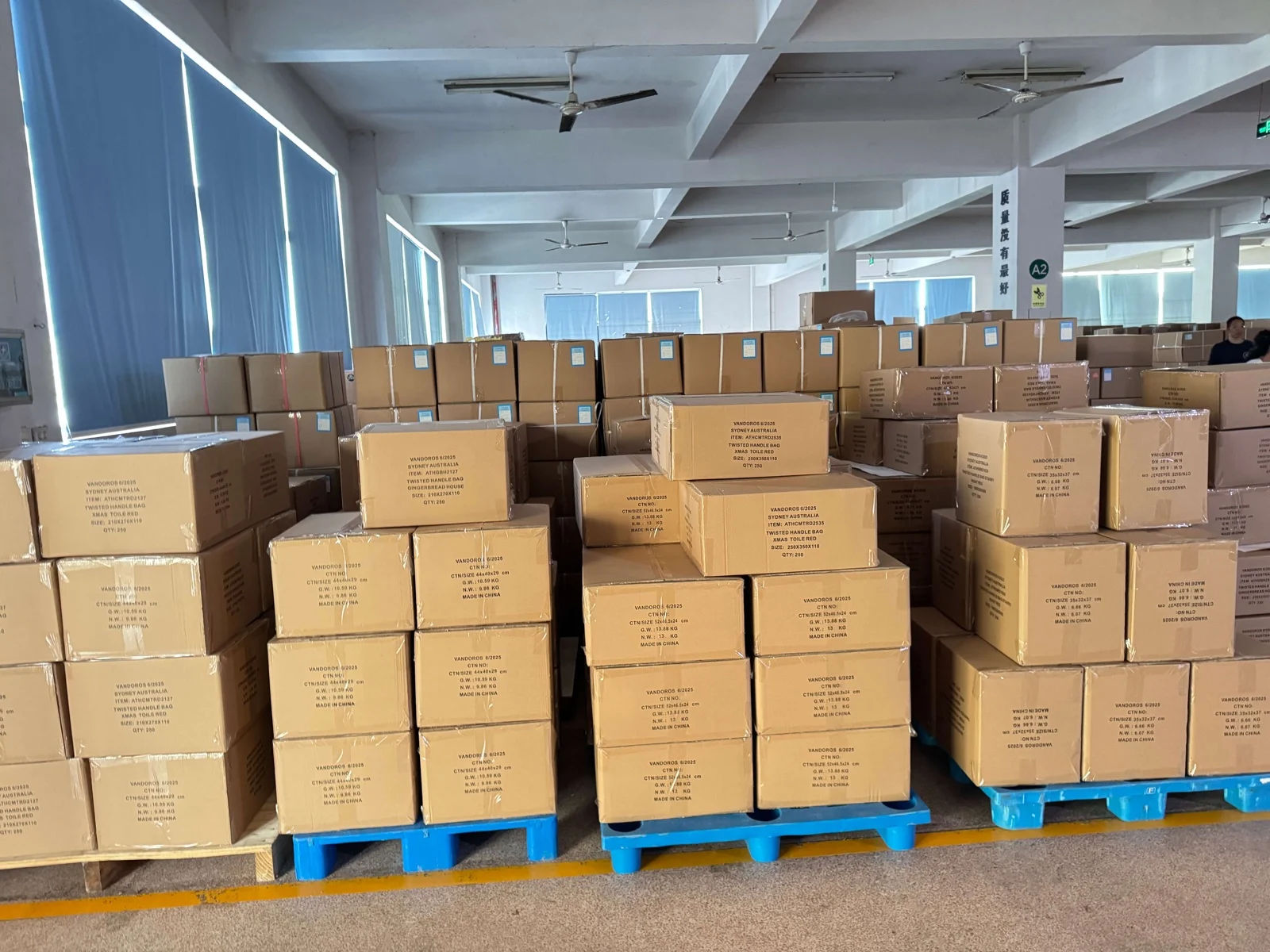 Finished Christmas cracker cartons staged in an organized warehouse
