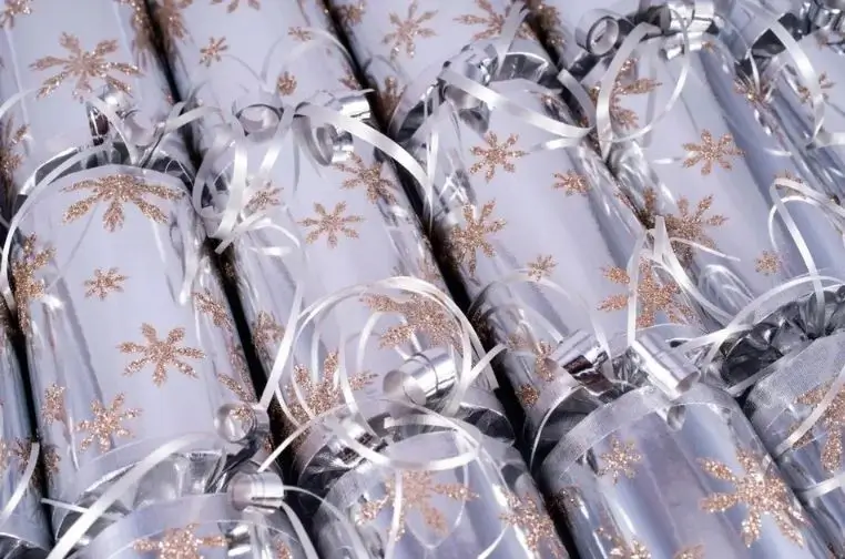 Branded luxury Christmas crackers with company logos and custom packaging, displayed at a festive corporate event, showing how businesses use them for marketing in 2025