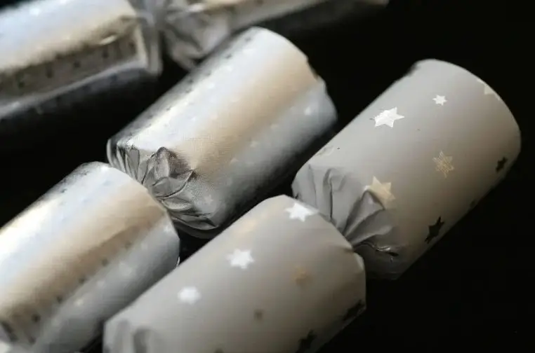 Vintage-style Christmas crackers alongside modern luxury designs, showing the evolution from traditional festive celebrations to stylish 2025 holiday trends