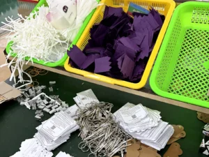 Christmas cracker gifts, inserts and components organized for production